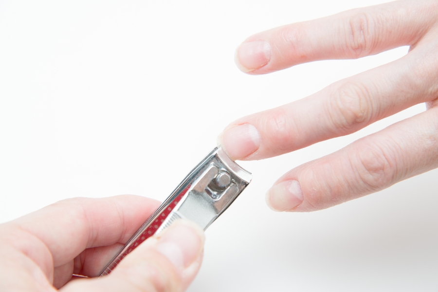 Dùng dụng cụ cắt tỉa gọn phần móng trước khi bôi dầu dừa